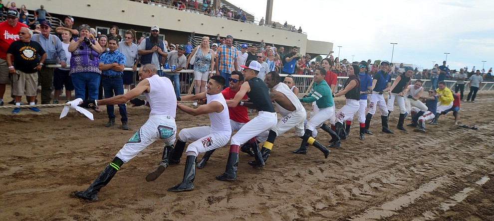 Jockeys from Arizona Downs dig deep as they take on Bradshaw Mountain High School football players in a tug-a-war Saturday, August 3, 2019, in on the racetrack in Prescott Valley. (Les Stukenberg/Courier)