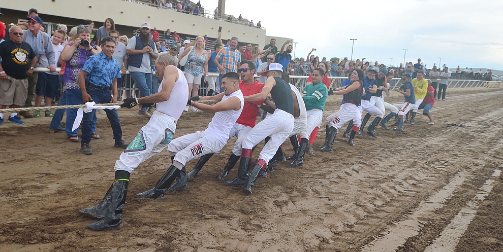 Jockeys from Arizona Downs dig deep as they take on Bradshaw Mountain High School football players in a tug-a-war Saturday, August 3, 2019, in on the racetrack in Prescott Valley. (Les Stukenberg/Courier)