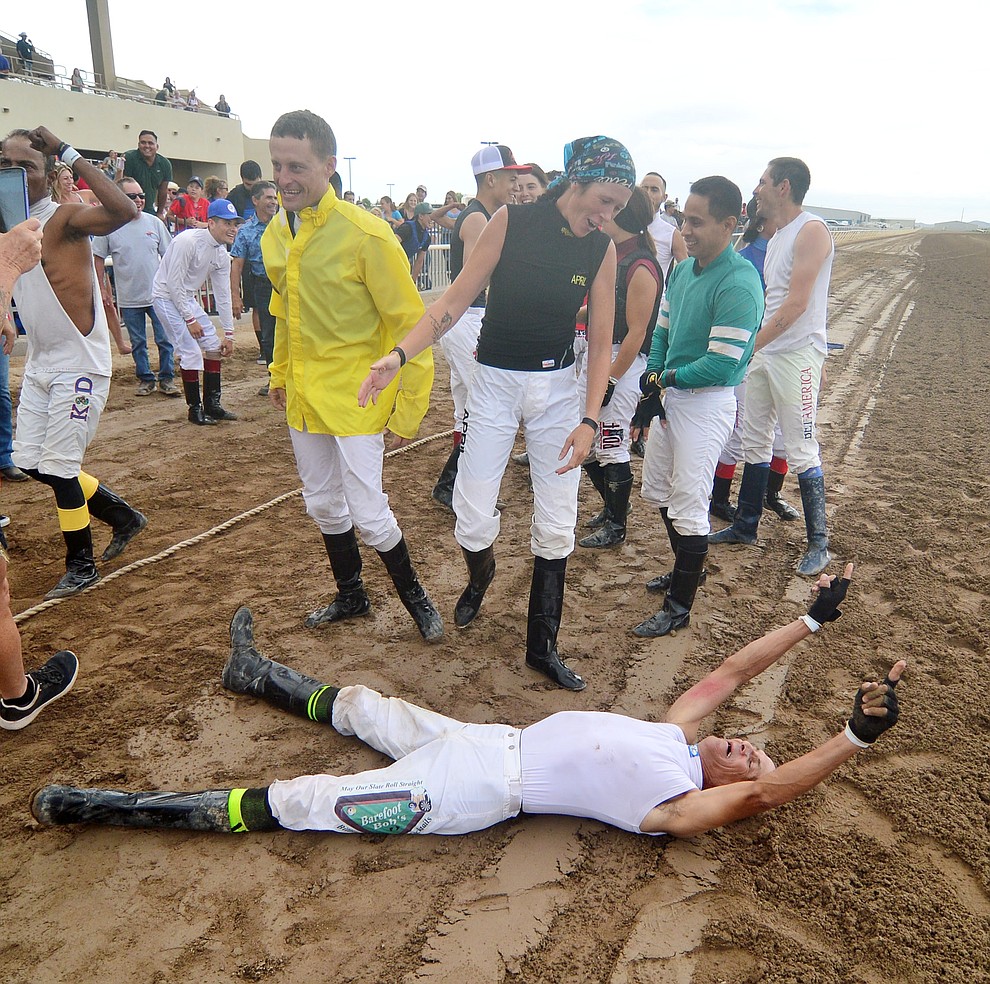 Richard Lull celebrates after the jockeys from Arizona Downs beat the Bradshaw Mountain High School football players in a tug-a-war Saturday, August 3, 2019, in on the racetrack in Prescott Valley. (Les Stukenberg/Courier)