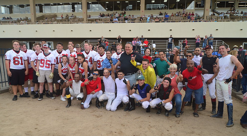 Bradshaw Mountain High School football players and jockeys from Arizona Downs gather after a competitive tug-a-war Saturday, August 3, 2019, in on the racetrack in Prescott Valley. (Les Stukenberg/Courier)