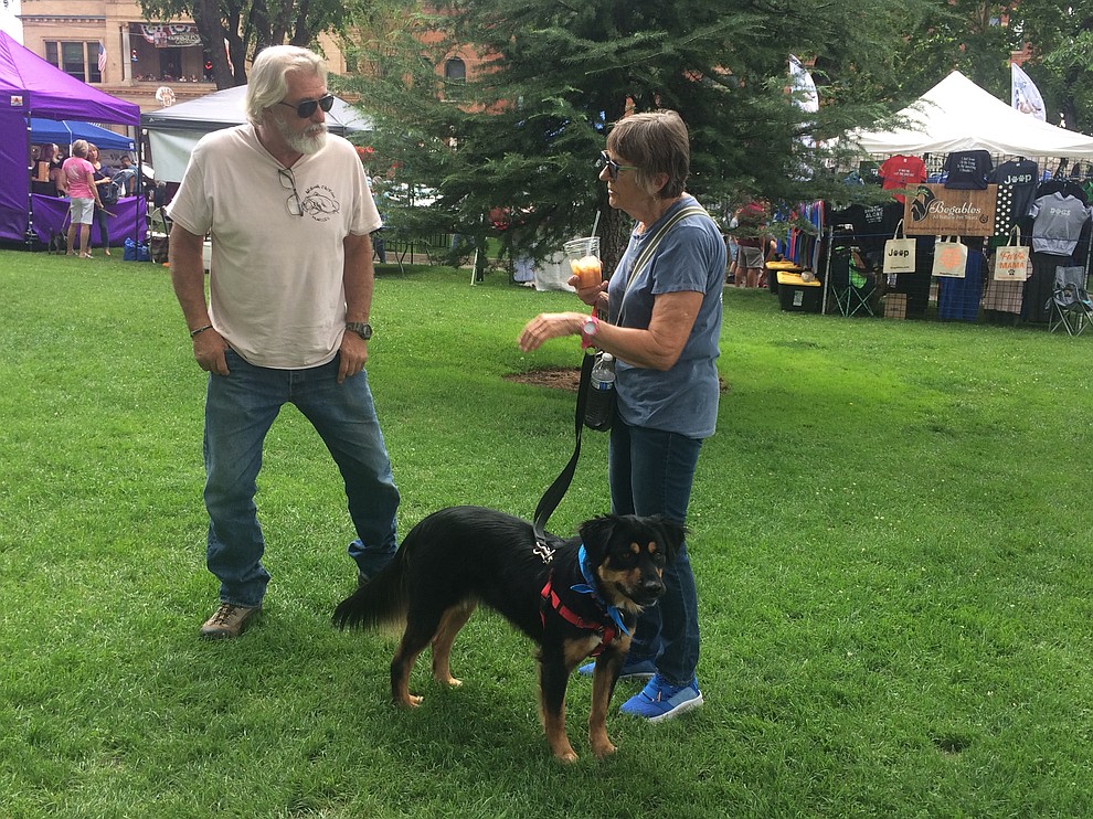 H.T. Sartin and Rosita Wood with Lassie, a dog up for adoption, at the Woof Down Lunch event at courthouse plaza Saturday, Aug. 3. (Jason Wheeler/Courier)