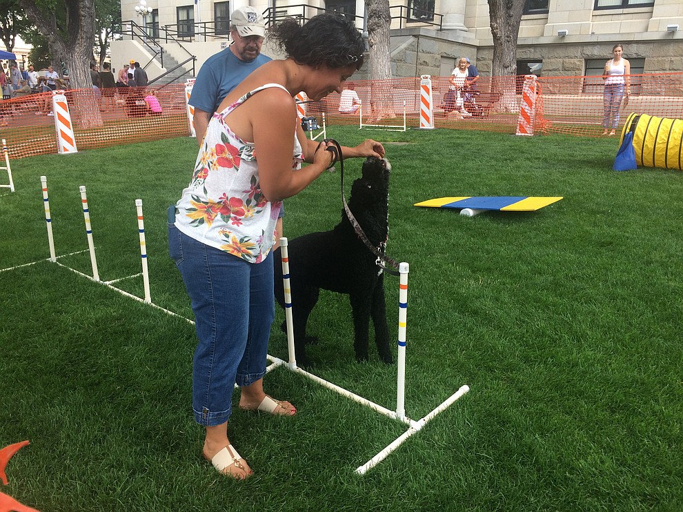 Michele Keck gives her dog, Luna, a treat while taking her through the agility course at the Woof Down Lunch event at courthouse plaza Saturday, Aug. 3. (Jason Wheeler/Courier)