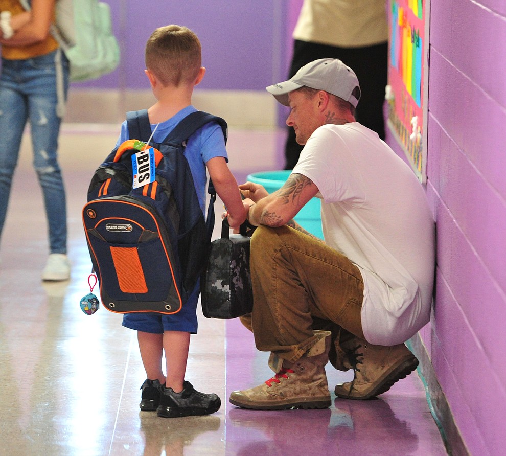 Lawrence Easthouse and his son Ronyn wait for kindergarten to start as students in the Humboldt Unified School District returned to school at Coyote Springs Elementary School Monday, August 5, 2019, in Prescott Valley.  (Les Stukenberg/Courier)