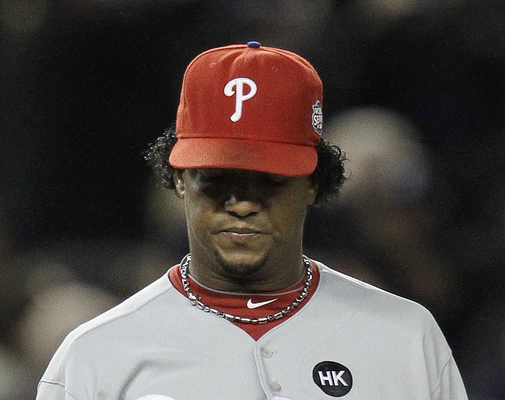 In this Nov. 4, 2009, file photo, Philadelphia Phillies' Pedro Martinez looks at his ball after giving up a two-run home run to New York Yankees' Hideki Matsui during the second inning of Game 6 of the Major League Baseball World Series in New York. The Phillies lost to the New York Yankees in six games and Martinez went 0-2 in two starts against the Yankees with a 6.30 ERA _ but has long said he was sick in his Game 6 start at Yankee Stadium and always wished he could have that one back. (David J. Phillip/AP, file)