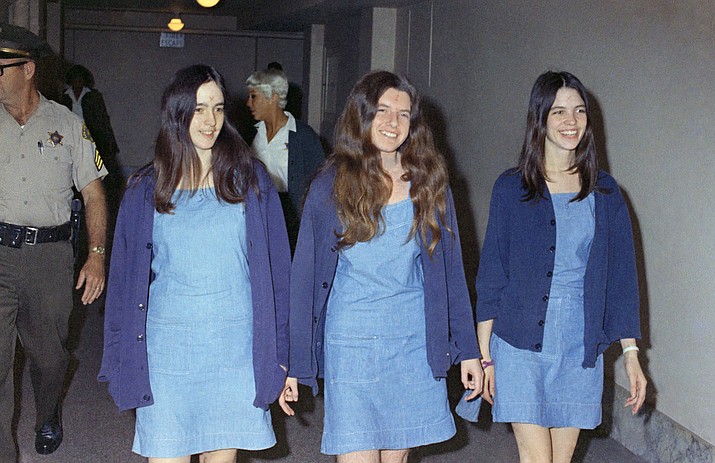 In this Aug. 20, 1970, file photo, Charles Manson followers, from left, Susan Atkins, Patricia Krenwinkel and Leslie Van Houten walk to court to appear for their roles in the 1969 cult killings of seven people in Los Angeles. Atkins estified she was "stoned on acid" and didn't know how many times she stabbed Tate as the actress begged for her life. She died in prison of cancer at age 61 in 2009. Krenwinkel testified at a 2016 parole hearing that she repeatedly stabbed Abigail Folger, then stabbed Leno LaBianca in the abdomen the following night and wrote "Helter Skelter," ″Rise" and "Death to Pigs" on the walls with his blood. Krenwinkel, 71, remains in prison. She didn't take part in the Tate killings but accompanied Manson and others to the LaBianca home the next night where she held Rosemary LaBianca down with a pillowcase over her head as others stabbed her dozens of times. She has been recommended for parole three times but former Gov. Jerry Brown blocked her release each time.(AP Photo/George Brich, File)