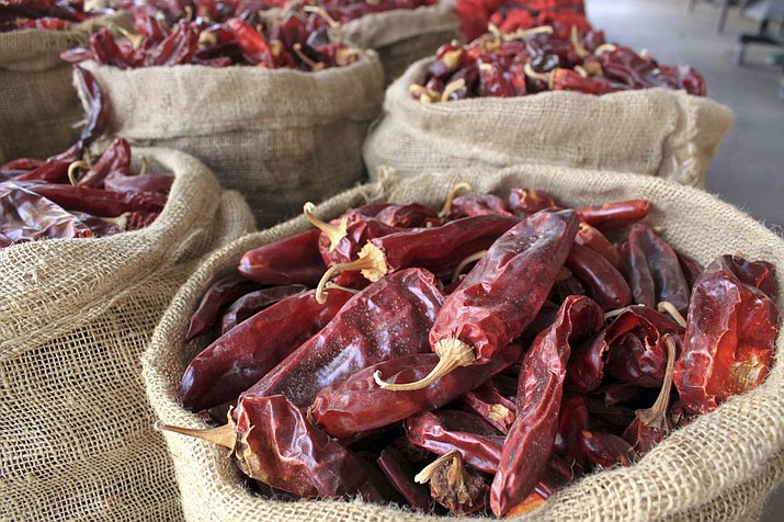 This March 20, 2013, file photo, shows sacks of dried red chile pods at the Hatch Chile Sales shop along the main street of the self-proclaimed "Chile Capital of the World," in Hatch, N.M. A hybrid version of a New Mexico chile plant has been selected to be grown in space as part of a NASA experiment, officials recently announced. (Susan Montoya Bryan/Associated Press)