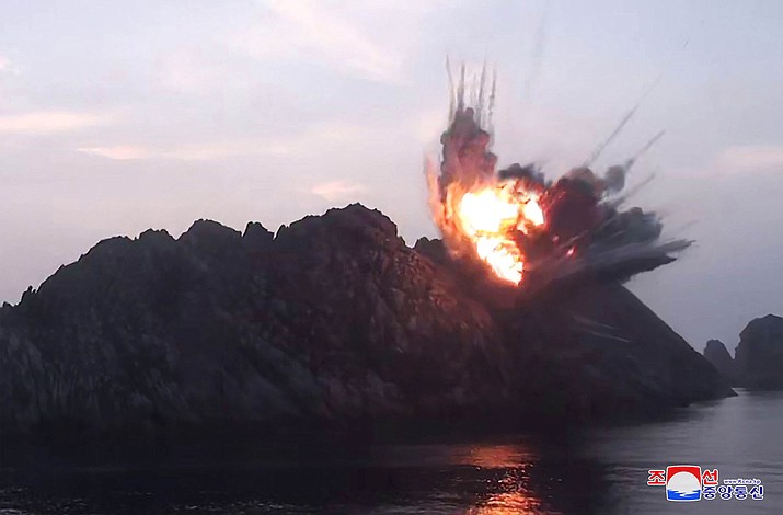 This Tuesday, Aug. 6, 2019, photo provided by the North Korean government shows what it says a new-type tactical guided missile launched from an airfield in the western area of North Korea landing in an islet in waters off the country's eastern coast. Independent journalists were not given access to cover the event depicted in this image distributed by the North Korean government. The content of this image is as provided and cannot be independently verified. Korean language watermark on image as provided by source reads: "KCNA" which is the abbreviation for Korean Central News Agency. (Korean Central News Agency/Korea News Service via AP)