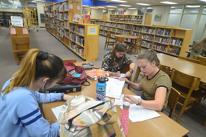 Annabel Young, Arden Cherry and Meghan Kloos do homework in the Prescott High School library Tuesday, Aug. 6, 2019. (Les Stukenberg/Courier)