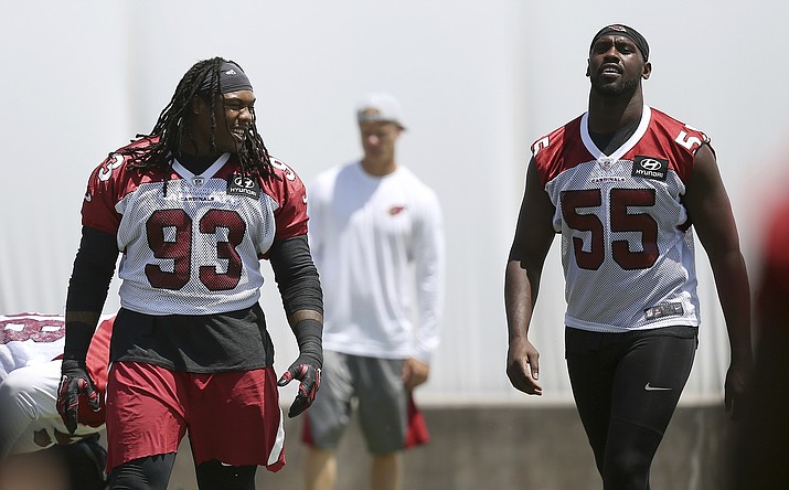 Arizona Cardinals linebacker Chandler Jones (55) and defensive lineman Darius Philon (93) chat as they warm up during drills at the team's training facility, Wednesday, June 12, 2019, in Tempe, Ariz. (AP Photo/Ross D. Franklin)