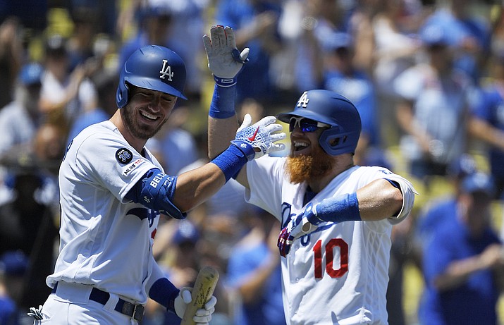 Los Angeles Dodgers' Justin Turner, right, hits a two-run home run