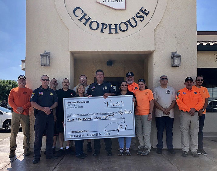 Jesse and Dondi Godinez, owners of the Kingman Chophouse, recently presented Mohave County Sheriff Doug Schuster and members of the Search and Rescue- Kingman Unit with a check for $6,900. (Photo courtesy of MCSO)