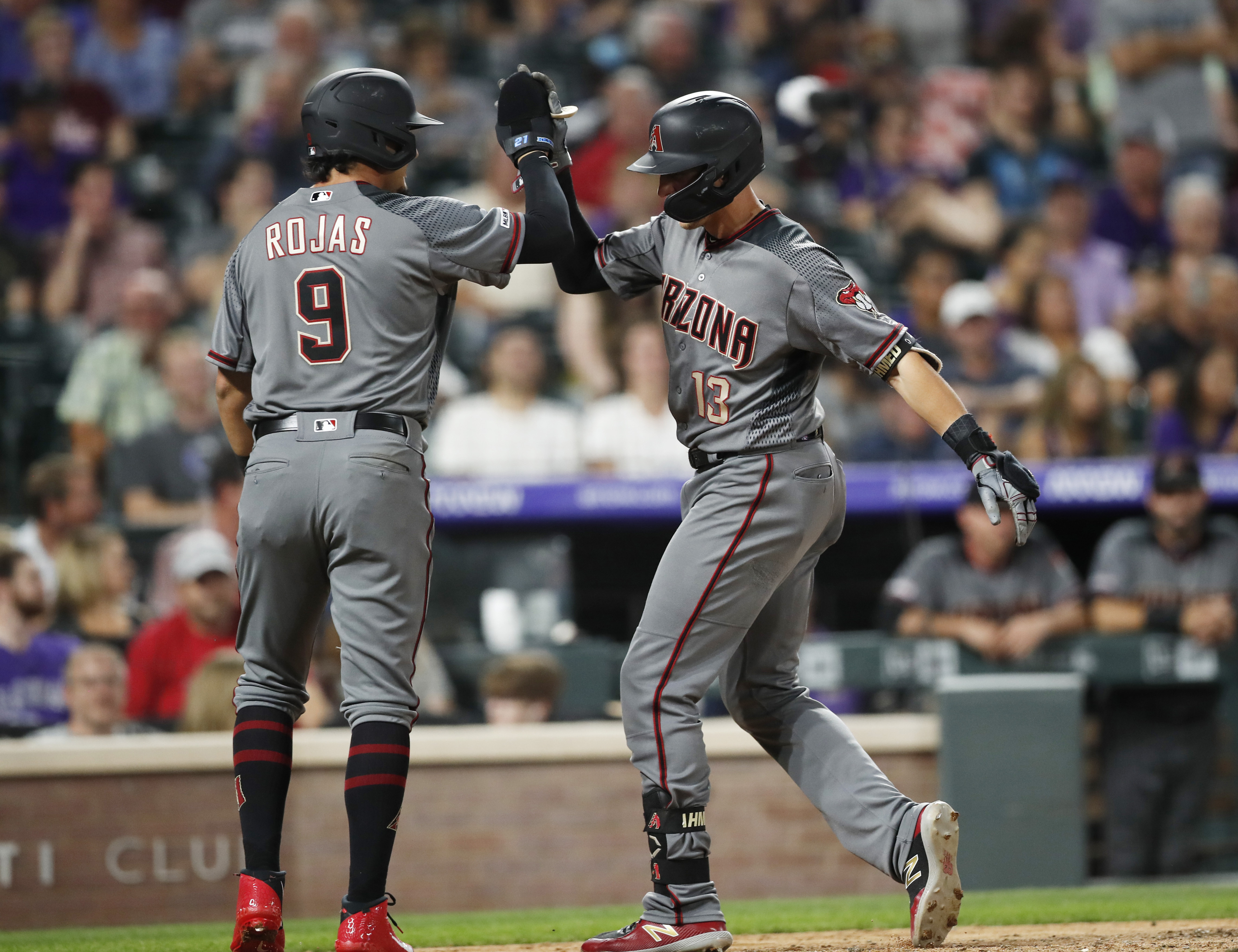 Nick Ahmed of the Arizona Diamondbacks celebrates in the dugout