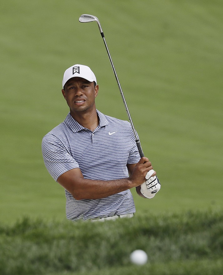 Tiger Woods watches his ball after hitting from a sand trap on the 14th hole during the pro-am round of the BMW Championship at Medinah Country Club, Wednesday, Aug. 14, 2019, in Medinah, Ill. (Nam Y. Huh/AP)