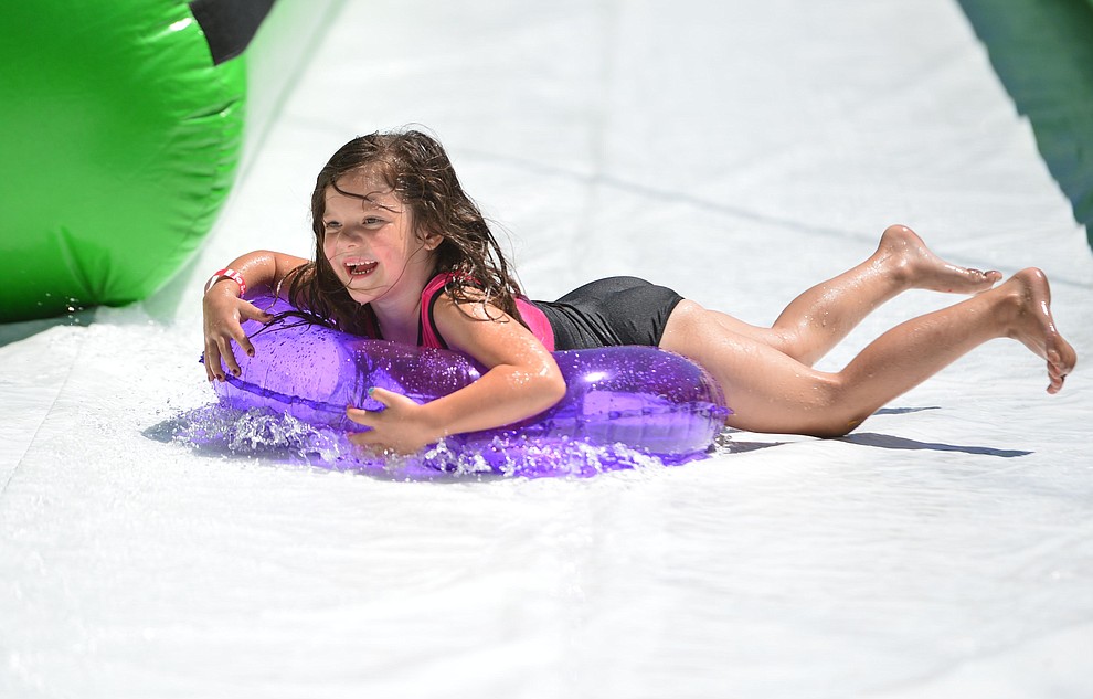 Genesis Scheffer from Prescott Valley is all smiles at the annual Monsoon Festival with the water slide that stetches most of the length of Union Street Saturday, August 17, 2019, in downtown Prescott. (Les Stukenberg/Courier)