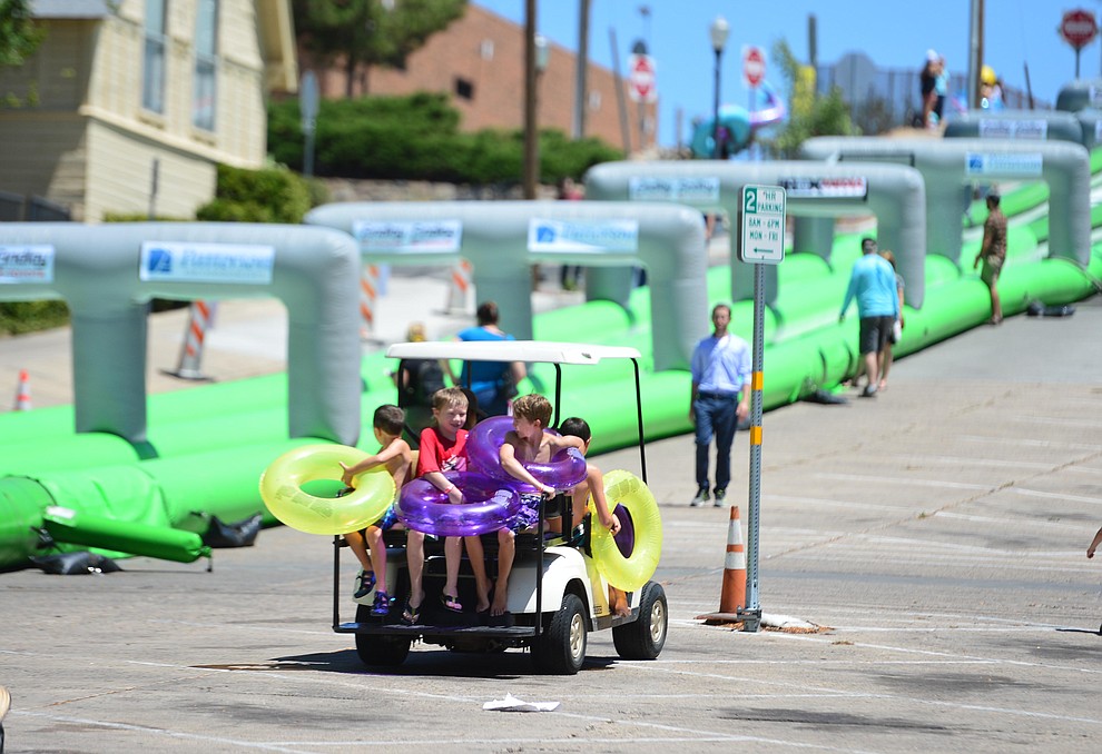 Rides to the top were popular at the annual Monsoon Festival with the water slide that stetches most of the length of Union Street Saturday, August 17, 2019, in downtown Prescott. (Les Stukenberg/Courier)