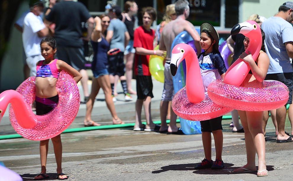 Jenizey Vargas with Sol and Dante Flores brought their own flamongos to the annual Monsoon Festival with the water slide that stetches most of the length of Union Street Saturday, August 17, 2019, in downtown Prescott. (Les Stukenberg/Courier)