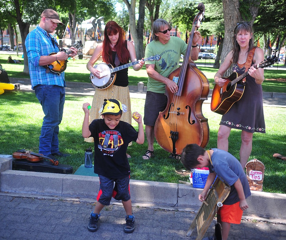 Jayden and Ethan Baltazar help the Just 4 Mama band at the annual Monsoon Festival with the water slide that stetches most of the length of Union Street Saturday, August 17, 2019, in downtown Prescott. (Les Stukenberg/Courier)