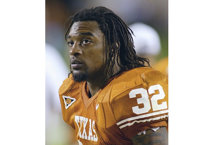 In this Nov. 6, 2004 photo, Texas running back Cedric Benson is shown in the bench area during his team’s 56-35 victory over Oklahoma State in Austin, Texas. Benson, one of the most prolific rushers in NCAA and University of Texas history, died in a motorcycle accident in Texas, Saturday, Aug. 17, 2019. He was 36. (Harry Cabluck/AP, file)