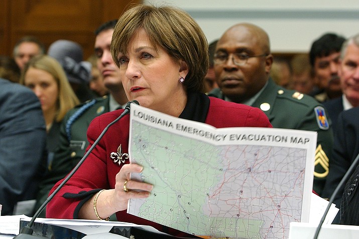 In this Dec. 14, 2005 photo, Louisiana Gov. Kathleen Blanco holds a map as she testifies on Capitol Hill, during a House Select Committee hearing on Hurricane Katrina. Blanco, who became Louisiana's first female elected governor only to see her political career derailed by the devastation of Hurricane Katrina, died Sunday, Aug. 18, 2019. She was 76. (Dennis Cook/AP, file)
