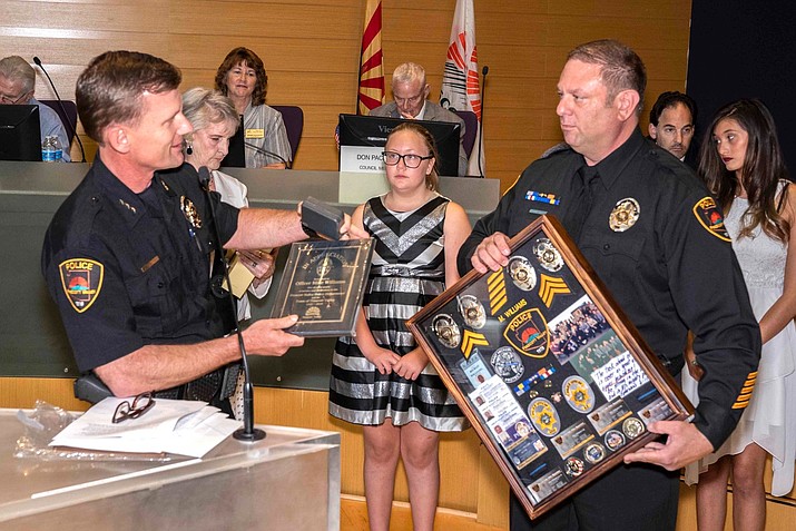 Prescott Valley Police Department Officer Mike Williams accepts his retirement plaque during a ceremony at the Town Council meeting Aug. 8, 2019, in Prescott Valley. (PVPD/Courtesy)