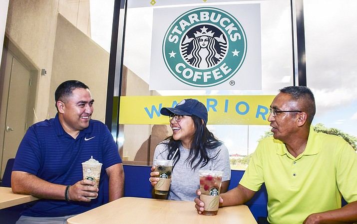 Diné College psychology graduate Travis Teller, psychology student Christina Bia and Franklin Sage, Ph.D., director of the Diné Policy Institute at Diné College, imbibe free coffee drinks offered at the 'soft opening' of Warrior Coffee at Diné College. The coffee shop serves Starbucks-styled coffee and Navajo tea, among other menu items. (Photo/Dine College)