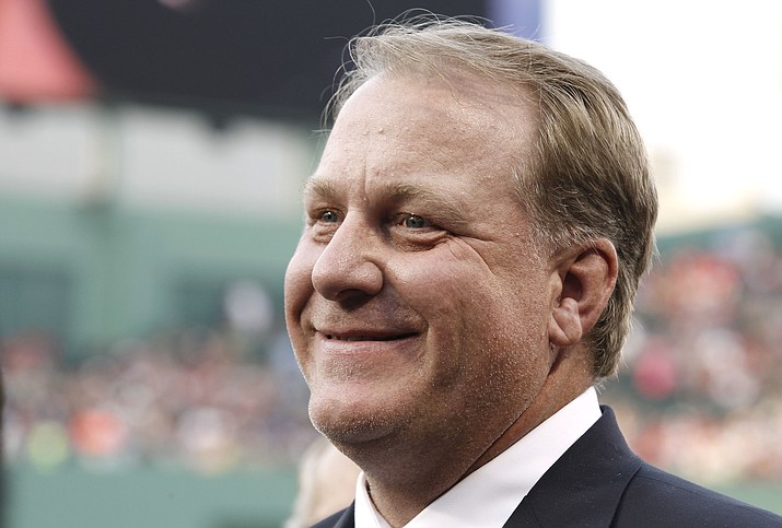 This Aug. 3, 2012, photo, shows former Boston Red Sox pitcher Curt Schilling smiling after being introduced at Fenway Park in Boston. Schilling says he might challenge Democratic U.S. Rep. Tom O'Halleran if he runs in Arizona. The Arizona Republic reported Wednesday, Aug. 21, 2019, that Schilling announced last week that he's thinking about running for Congress and has reached out to the Arizona Republican Party. (Winslow Townson/AP, File)