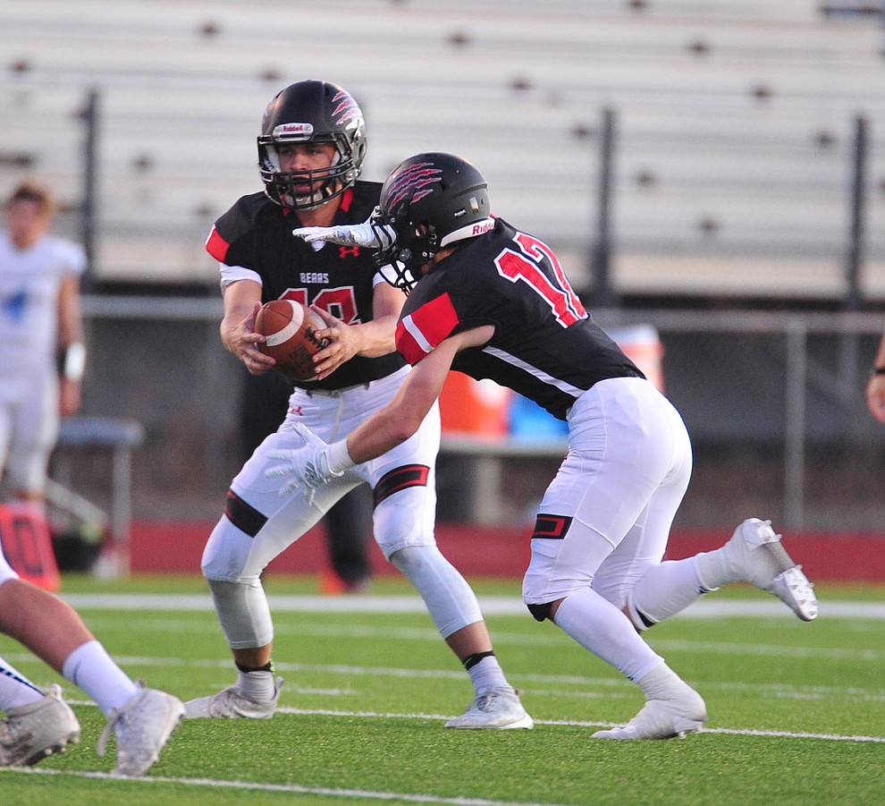 Bradshaw Mountain's Jos h Grant hands off to Titus King as the Bears host Estrella Foothills in their 2019 football home opener Friday, Aug. 23, 2019, in Prescott Valley. (Les Stukenberg/Courier)
