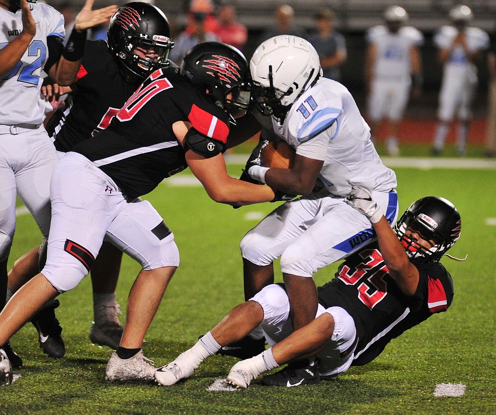 Bradshaw Mountain's Roberto Gonzalez and Eladio Rodriguez make a tackle as the Bears host Estrella Foothills in their 2019 football home opener Friday, Aug. 23, 2019, in Prescott Valley. (Les Stukenberg/Courier)