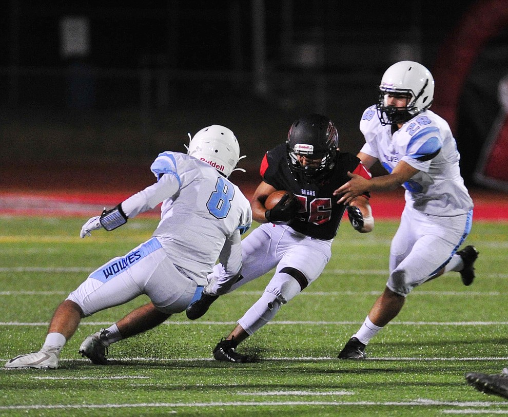 Bradshaw Mountain's Elijah Acuna tries to split two defenders as the Bears host Estrella Foothills in their 2019 football home opener Friday, Aug. 23, 2019, in Prescott Valley. (Les Stukenberg/Courier)