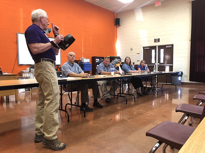 George Watt, president of the Williams Lions Club, demonstrates a Spot Vision Screener for the WUSD Governing Board Aug. 14. (Wendy Howell/WGCN)