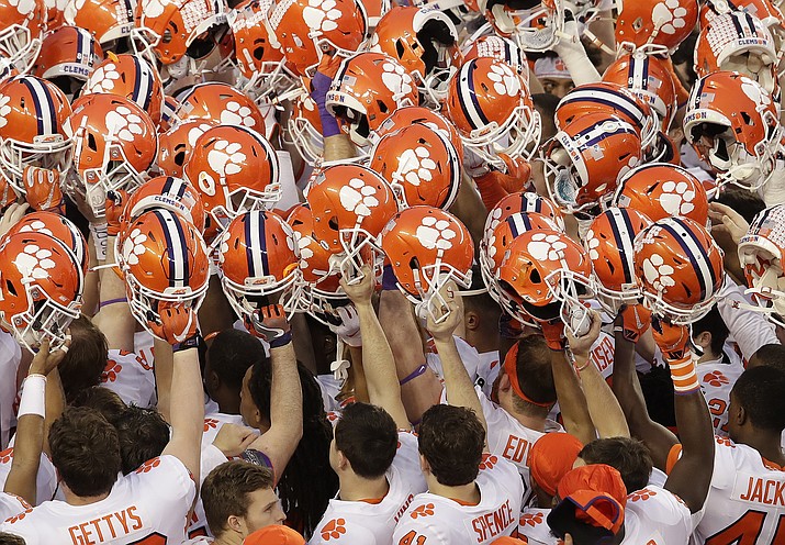 In this Jan. 7, 2019, photo, Clemson players huddle before the NCAA playoff championship game against Alabama, in Santa Clara, Calif. For the first time, the defending national champion Tigers are No. 1 in The Associated Press preseason Top 25 presented by Regions Bank, Monday, Aug. 19, 2019. (Jeff Chiu/AP, File)