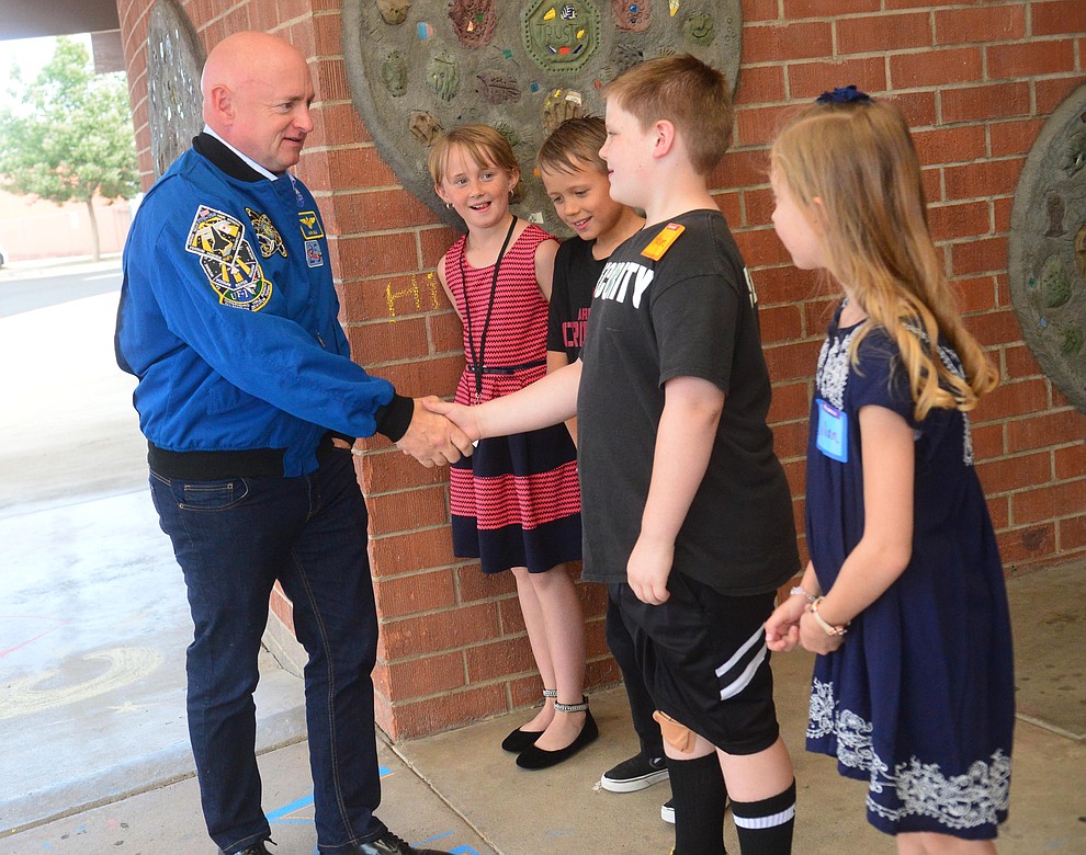 Former astronaut Mark Kelly is greeted by students Janie Waara, Jonah Waara, Mason White and Jillian Binder as he visits Taylor Hicks Elementary School in Prescott Thursday, Aug. 29, 2019. (Les Stukenberg/Courier)