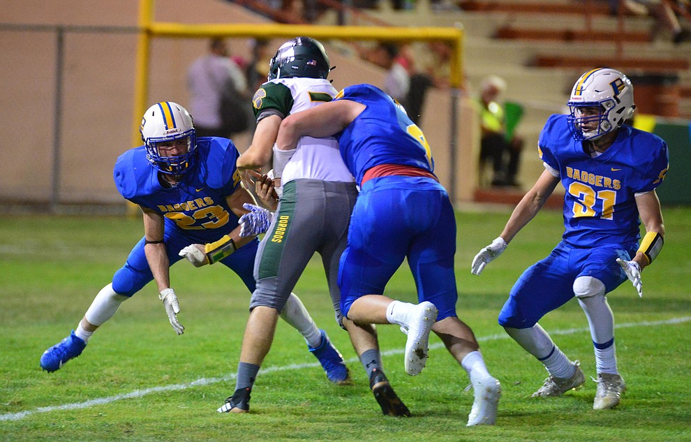 Prescott's sam Giordan (23), Aaron Greene (4) and Nathan Wright (31) tackle the punter for a big loss as the Badgers held their 2019 home opener at Ken Lindley Field Friday, Aug. 30, 2019.  (Les Stukenberg/Courier)