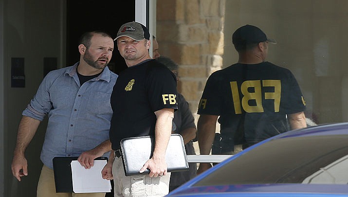 Law enforcement officials investigate Saturday's shooting at a shopping center Sunday, Sept. 1, 2019, in Odessa, Texas. (AP Photo/Sue Ogrocki)