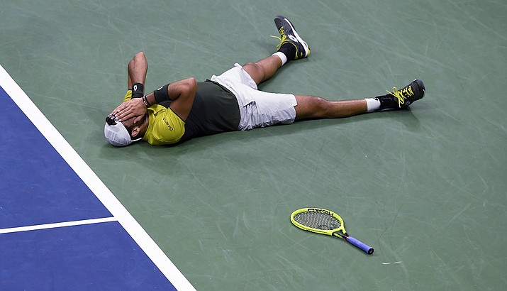 Matteo Berrettini, of Italy, falls to the court after winning the fifth set tie break for victory against Gael Monfils, of France, during the quarterfinals of the U.S. Open Wednesday, Sept. 4, 2019, in New York. (Sarah Stier/AP)