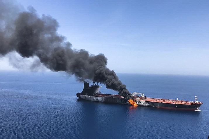 FILE - In this June 13, 2019 file photo, an oil tanker is on fire in the Gulf of Oman. The U.S. Navy is trying to put together a new coalition of nations to counter what it sees as a renewed maritime threat from Iran. Meanwhile, Iran finds itself backed into a corner and ready for a possible conflict. It stands poised on Friday, Sept. 6, 2019, to further break the terms of its 2015 nuclear deal with world powers. (AP Photo/ISNA, File)