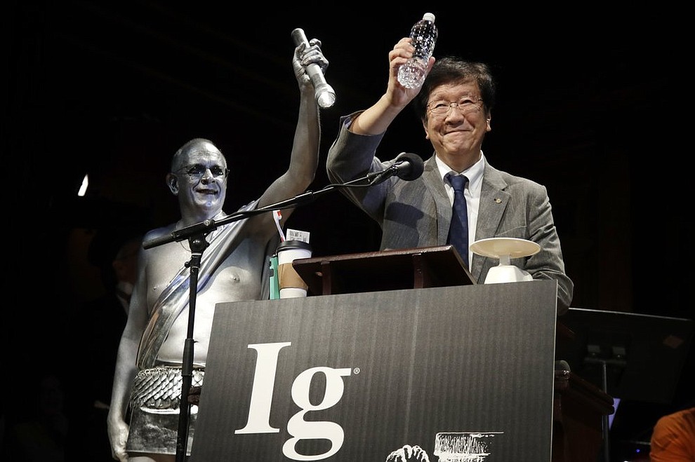 Shigeru Watanabe, of Japan, receives the Ig Nobel award in chemistry for estimating the total saliva volume produced per day by a typical five-year-old, at the 29th annual Ig Nobel awards ceremony at Harvard University, Thursday, Sept. 12, 2019, in Cambridge, Mass. The spoof prizes for weird and sometimes head-scratching scientific achievement are bestowed by the Annals of Improbable Research magazine, and handed out by real Nobel laureates. (AP Photo/Elise Amendola)