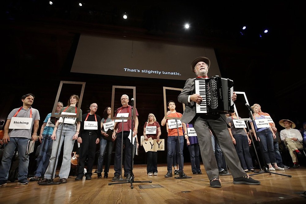 Dr. Thomas Michael plays the accordion as the ensemble performs, "The Creatures of Habit Opera" at the 29th annual Ig Nobel awards ceremony at Harvard University, Thursday, Sept. 12, 2019, in Cambridge, Mass. The spoof prizes for weird and sometimes head-scratching scientific achievement are bestowed by the Annals of Improbable Research magazine, and handed out by real Nobel laureates. (AP Photo/Elise Amendola)