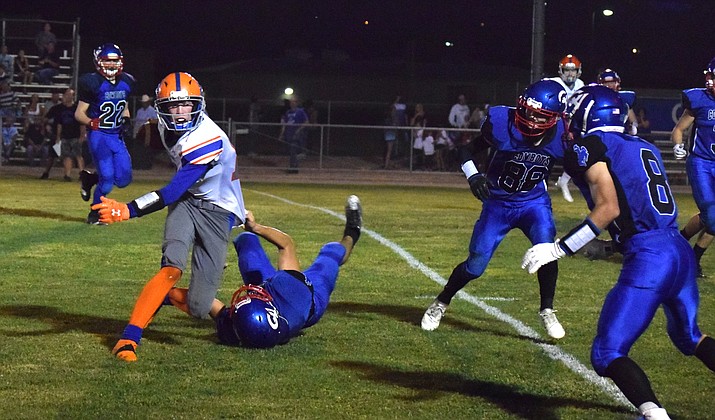 Camp Verde junior Jacob Kane pulls down a Cougar during the Cowboys’ 44-6 loss to Chino Valley on Friday night at home. VVN/James Kelley