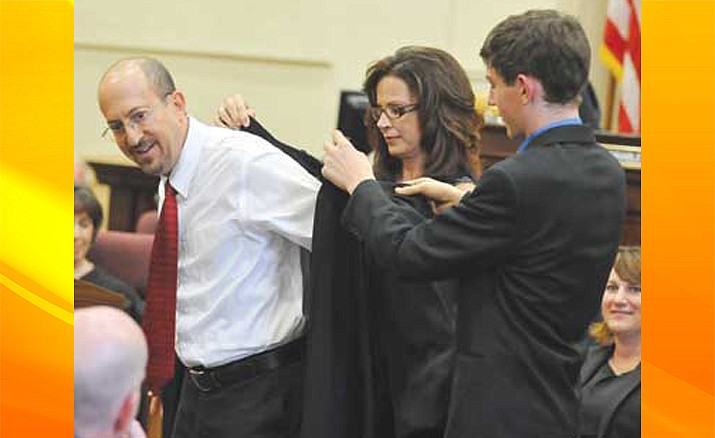 Joseph Goldstein gets his robe from his wife, Lisa, and son, Alexander, during his investiture as a commissioner to the Yavapai County Family Law court in August 2011 in Prescott. Goldstein is one of four nominees for an Arizona Court of Appeals seat. (Les Stukenberg/Courier, file)