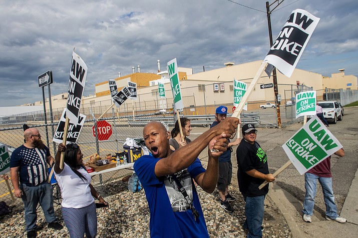Flint resident Jashanti Walker, who has been a first shift team leader in the body shop for two years, demonstrates with more than a dozen other General Motors employees outside of the Flint Assembly Plant on Sunday, Sept. 15, 2019, in Flint, Mich. The United Auto Workers union says its contract negotiations with GM have broken down and its members will go on strike just before midnight on Sunday. (Jake May/The Flint Journal via AP)