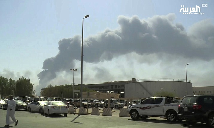 FILE - In this Saturday, Sept. 14, 2019 file photo, made from a video broadcast on the Saudi-owned Al-Arabiya satellite news channel, smoke from a fire at the Abqaiq oil processing facility fills the skyline, in Buqyaq, Saudi Arabia. The weekend drone attack on one of the world’s largest crude oil processing plants that dramatically cut into global oil supplies is the most visible sign yet of how Aramco’s stability and security is directly linked to that of its owner -- the Saudi government and its ruling family. (Al-Arabiya via AP, File)