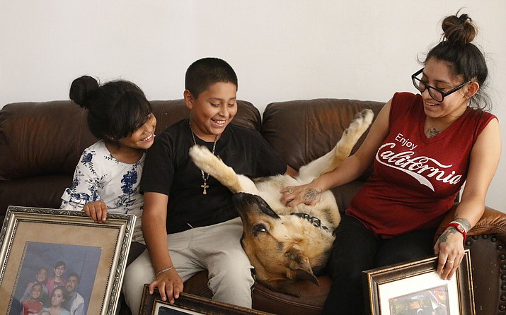 Max, the family dog, joined Guadalupe, Jose and Stacy in their new home. The Molina family’s recent move provides an uplifting change of scenery after their mother’s arrest. (Annika Tomlin/Cronkite News)