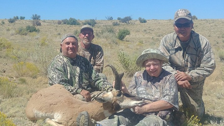 Page McDonald of Kingman holds the head of the antelope she harvested. She is accompanied by, from left, Marc Schwartzkopf, Hogan Roberts and Jay Chan. (Photo by Don Martin/For the Miner)