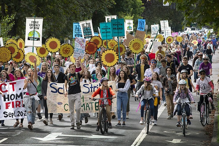 Local children protest after walking out of school as part of a worldwide School Strike for Climate change, Friday, Sept. 20, 2019 in Eugene, Ore. Young people afraid for their futures protested around the globe Friday to implore leaders to tackle climate change, turning out by the hundreds of thousands to insist that the warming world can't wait for action. (Andy Nelson/The Register-Guard via AP)