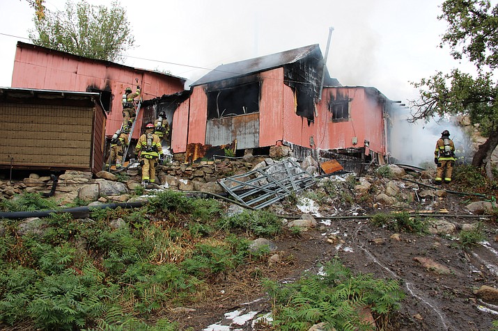 Firefighters put out hotspots at an abandoned building that caught fire near downtown Prescott Monday, Sept. 23, 2019. (Max Efrein/Courier)