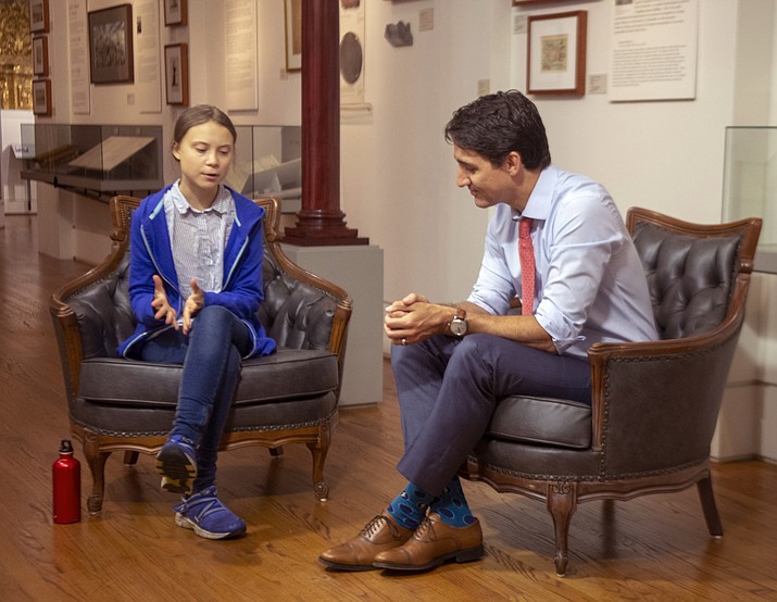 Canadian Prime Minister Justin Trudeau speaks Swedish environmental activist Greta Thunberg in Montreal on Friday, Sept. 27, 2019. Thunberg says she delivered the same message to Trudeau that she gives to all politicians -- that he needs to listen to the science and act on it. (Ryan Remiorz/The Canadian Press via AP)