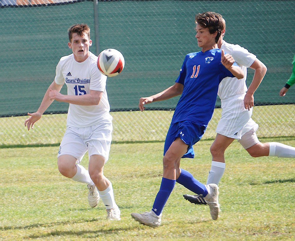 Chino Valley midfielder Quade Kellerman (11) corrals the ball between two defenders during the team's 8-2 win over Desert Christian on Saturday, Sept. 28, 2019, at Chino Valley High School. (Aaron Valdez/Courier)