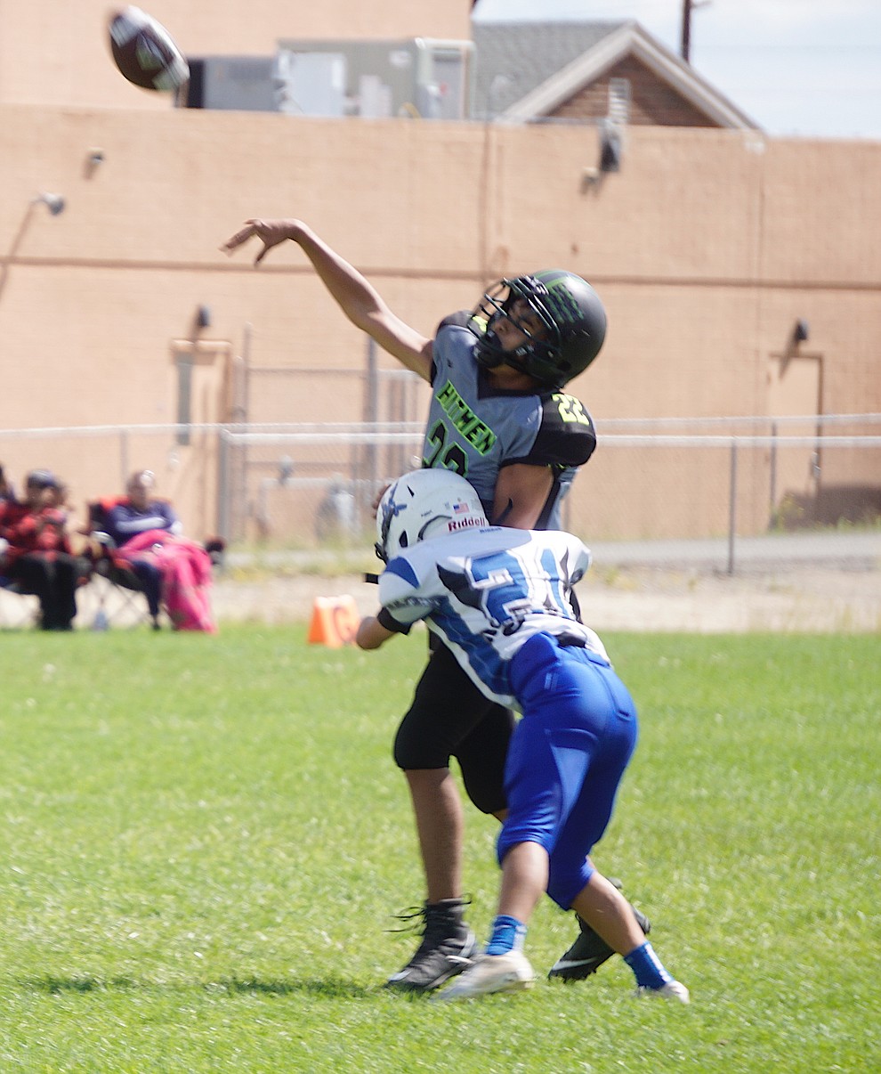 QB Gabriel Ricketts (22) of the Prescott Valley Hitmen Majors team thorws the ball down field while being tackled during their game against Bagdad on Saturday, Sept. 28, 2019, at Bradshaw Mountain Middle School. (Aaron Valdez/Courier)