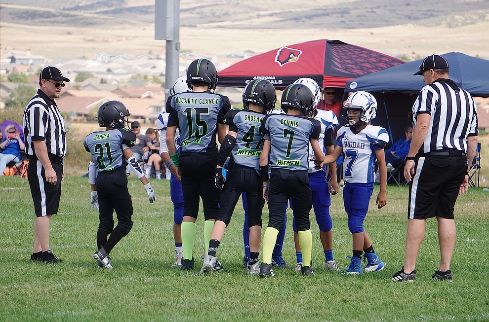 Captains Deion Zamora (21), Kamryn McCarty Glancy (15), Rex Shoemaker (47) and Steven Dennis (7) of the Prescott Valley Hitmen Majors team meet with the Bagdad captains before kickoff of a game on Saturday, Sept. 28, 2019, at Bradshaw Mountain Middle School. (Aaron Valdez/Courier)